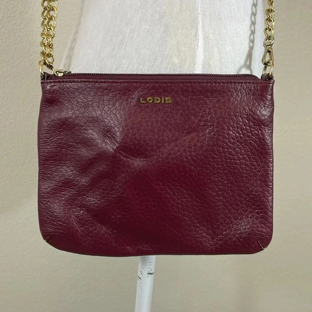 Lodis dark maroon crossbody purse with gold hardware